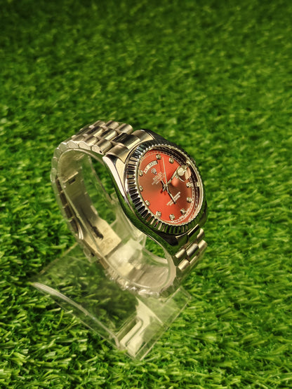 Silver watch with red dial